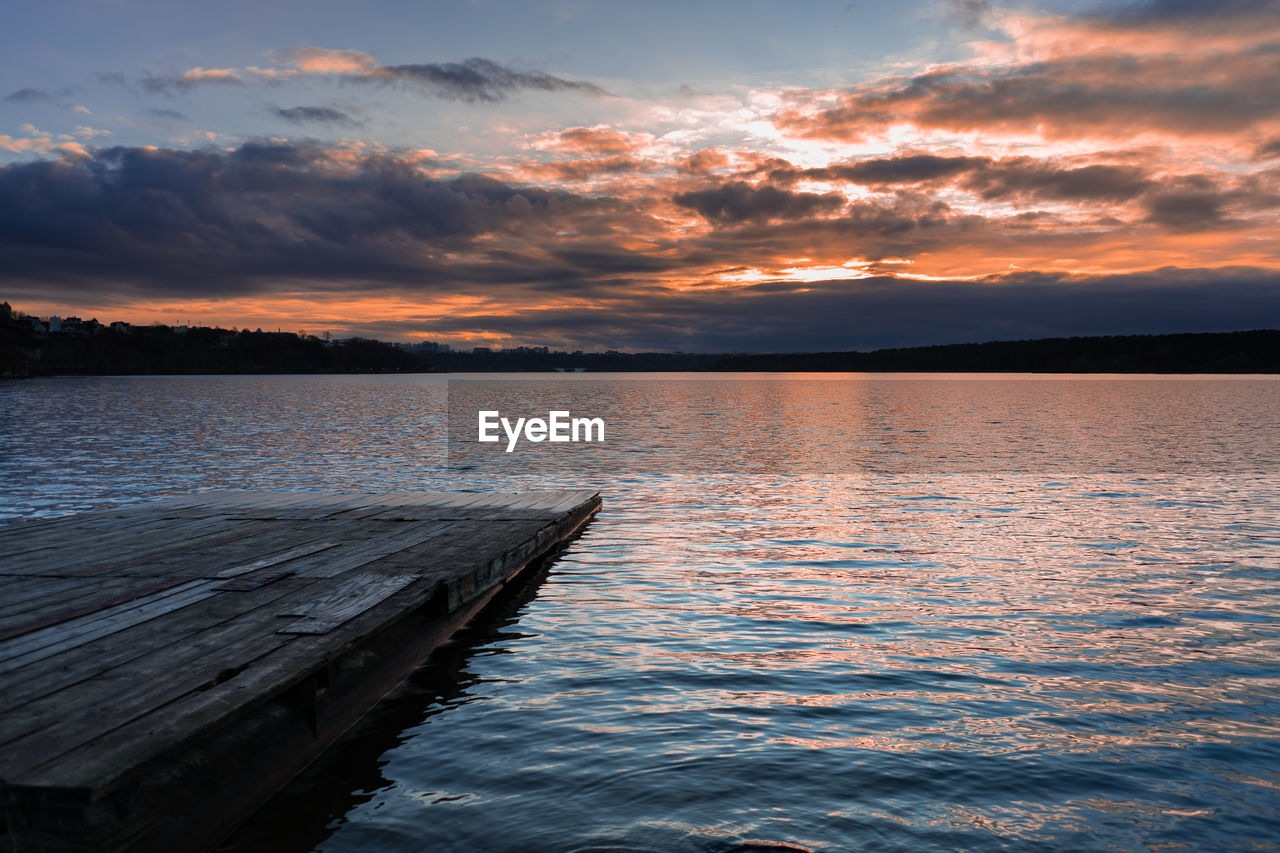 Scenic view of lake against sky during sunset