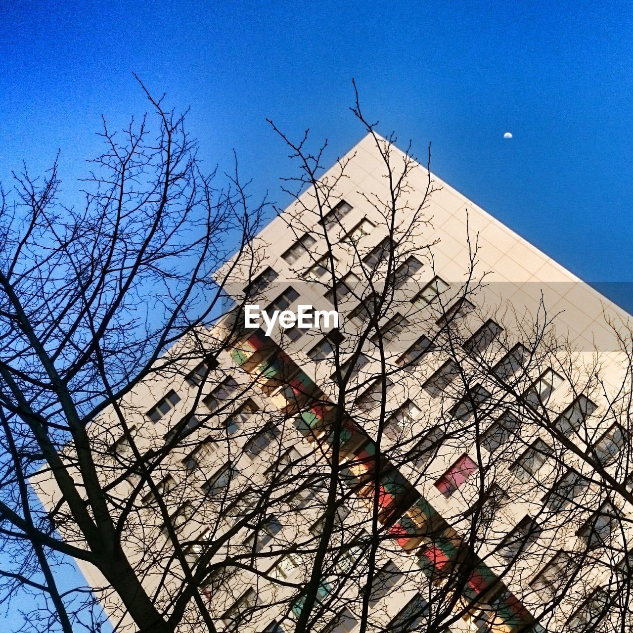 LOW ANGLE VIEW OF BUILT STRUCTURES AGAINST CLEAR BLUE SKY