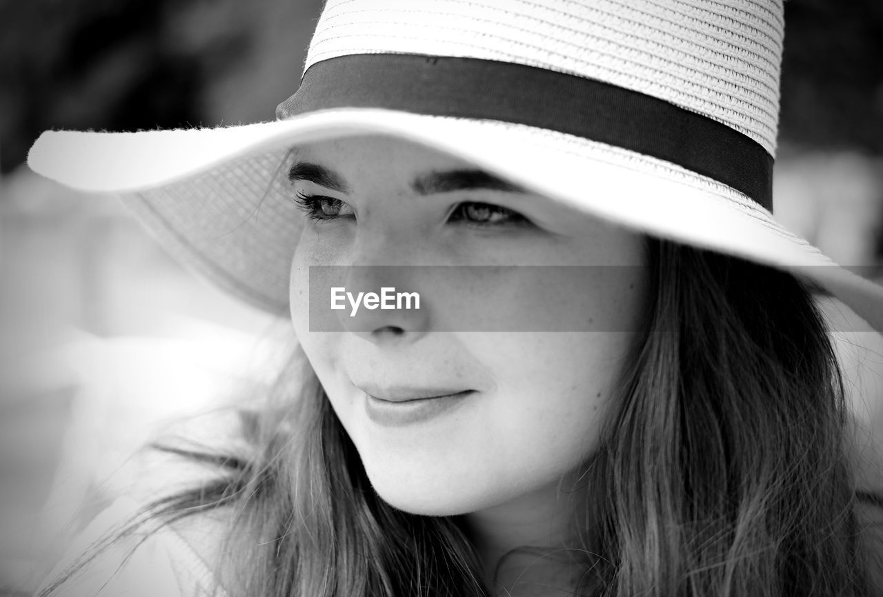 Close-up of cute girl wearing hat looking away