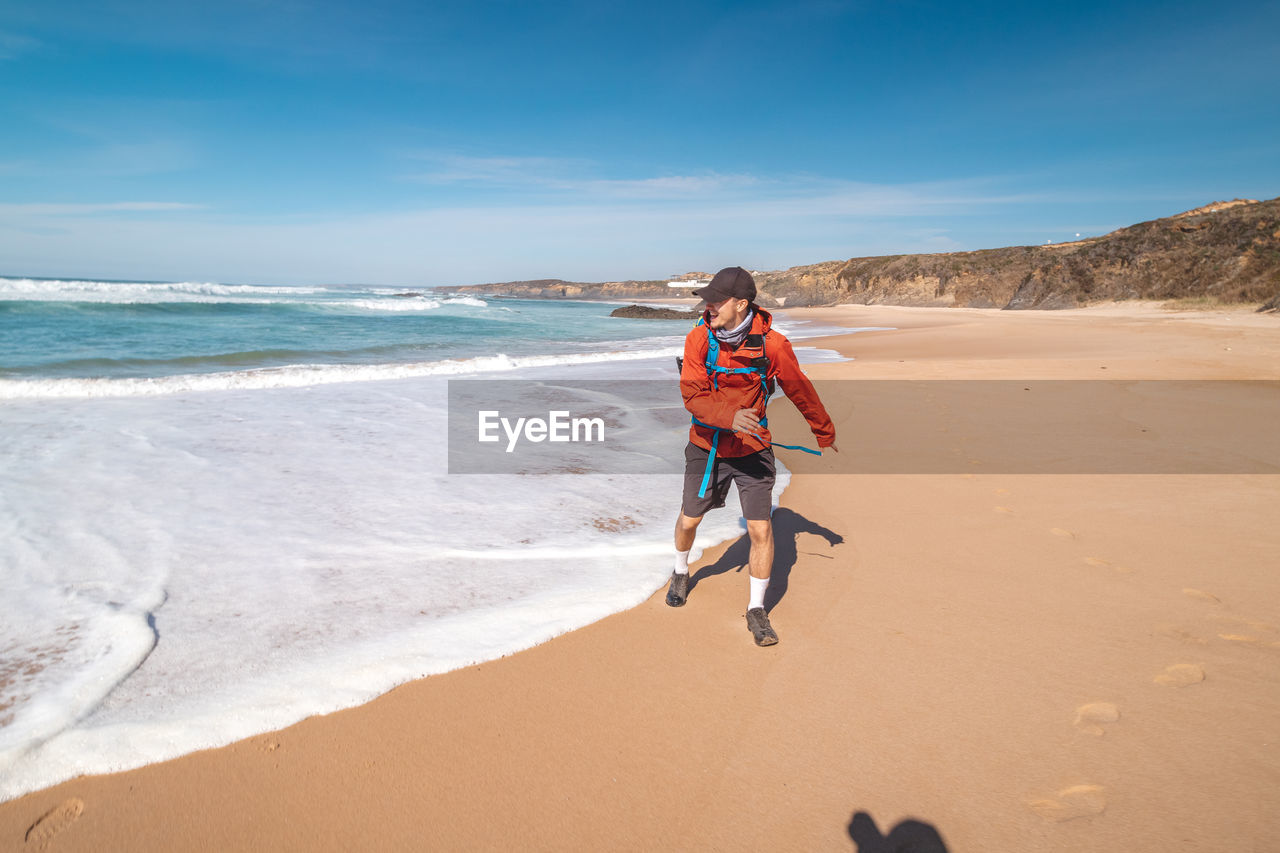 full length of woman walking on beach