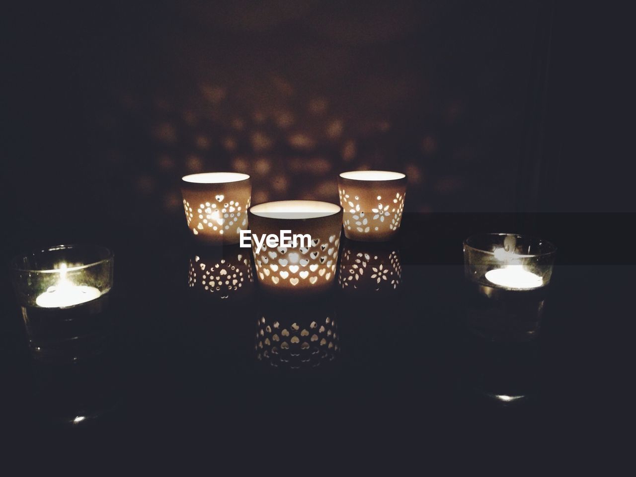 VIEW OF LIT CANDLES IN THE DARK