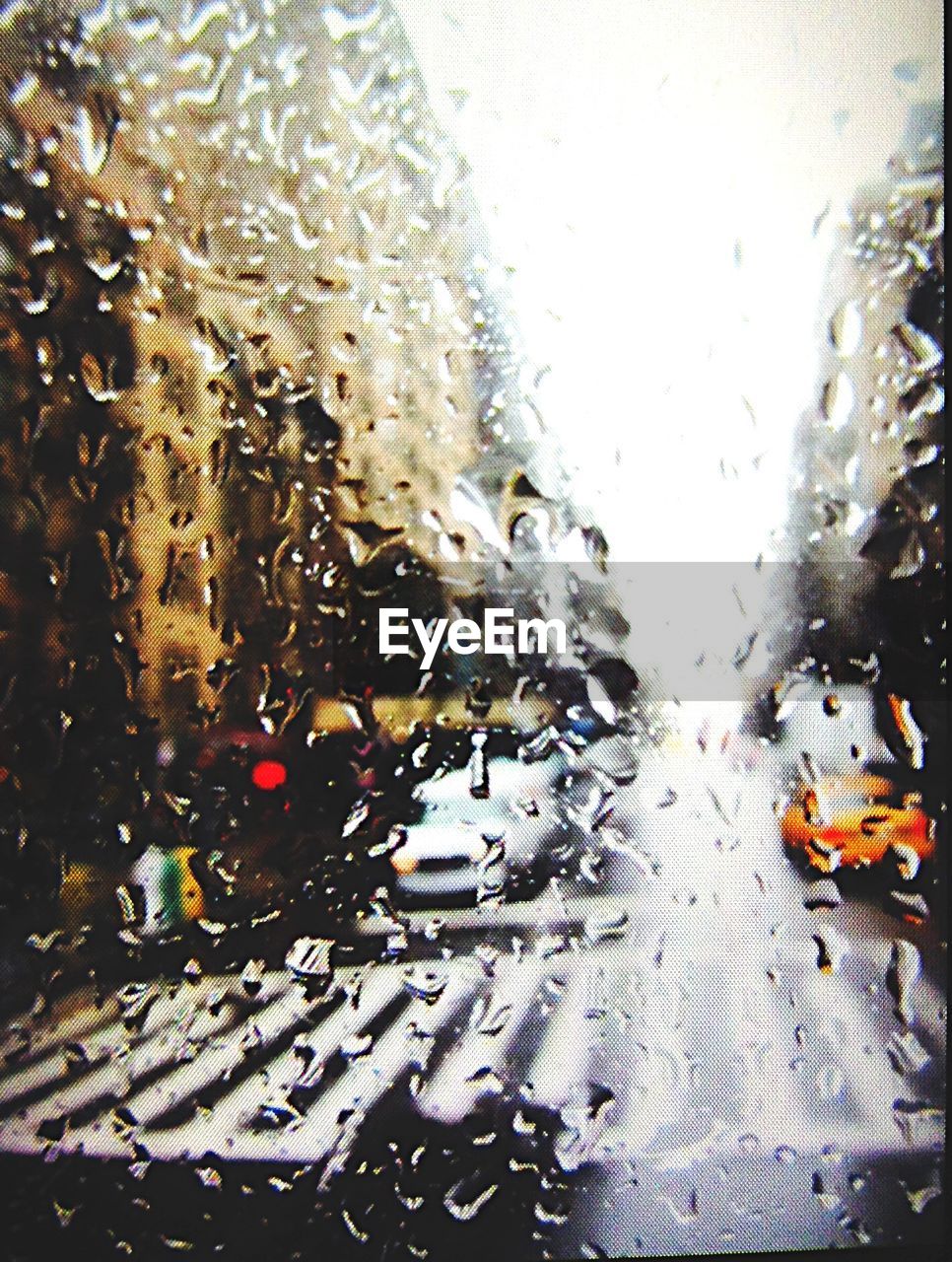 CLOSE-UP OF WATER DROPS ON WINDSHIELD