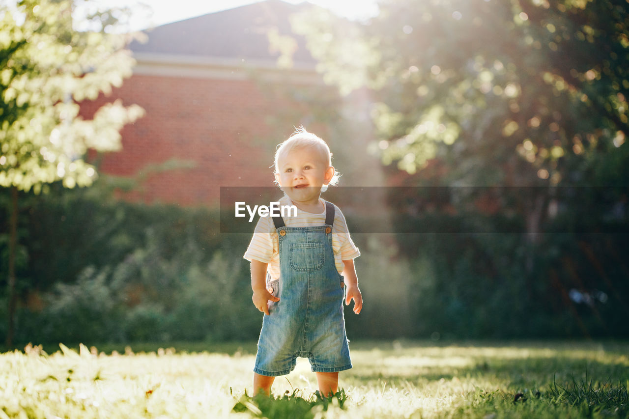 Cute boy looking away standing in park