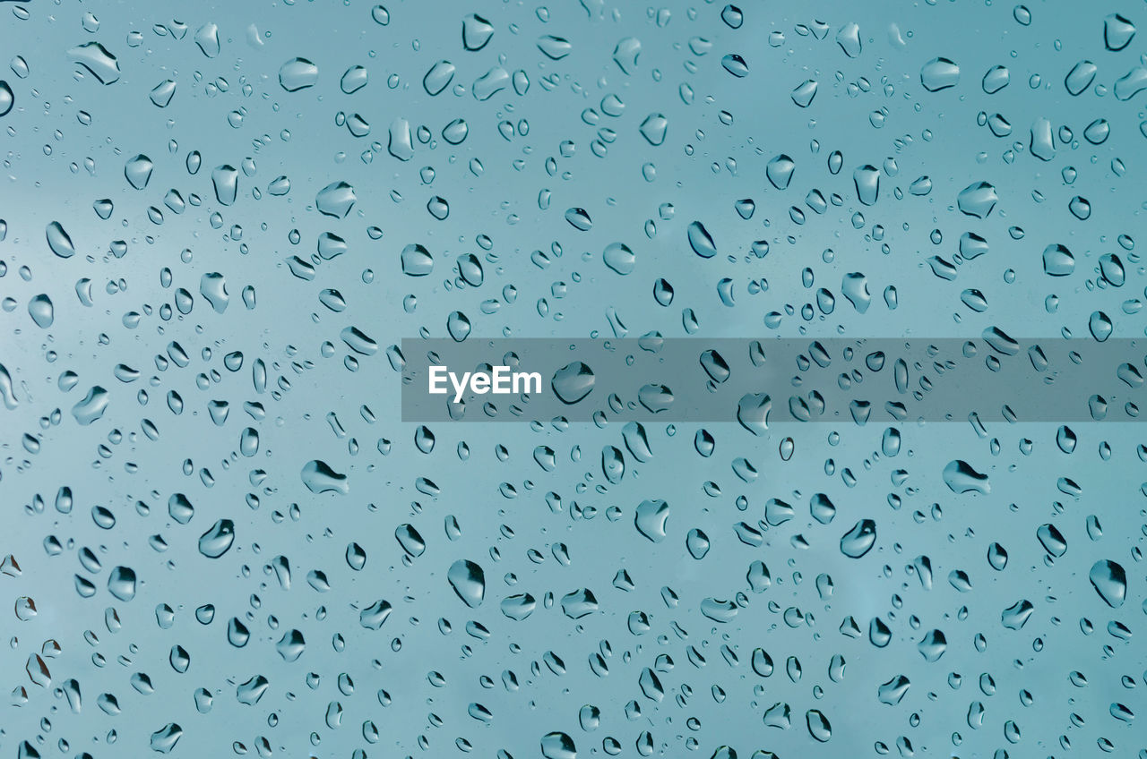 Full frame shot of raindrops on window