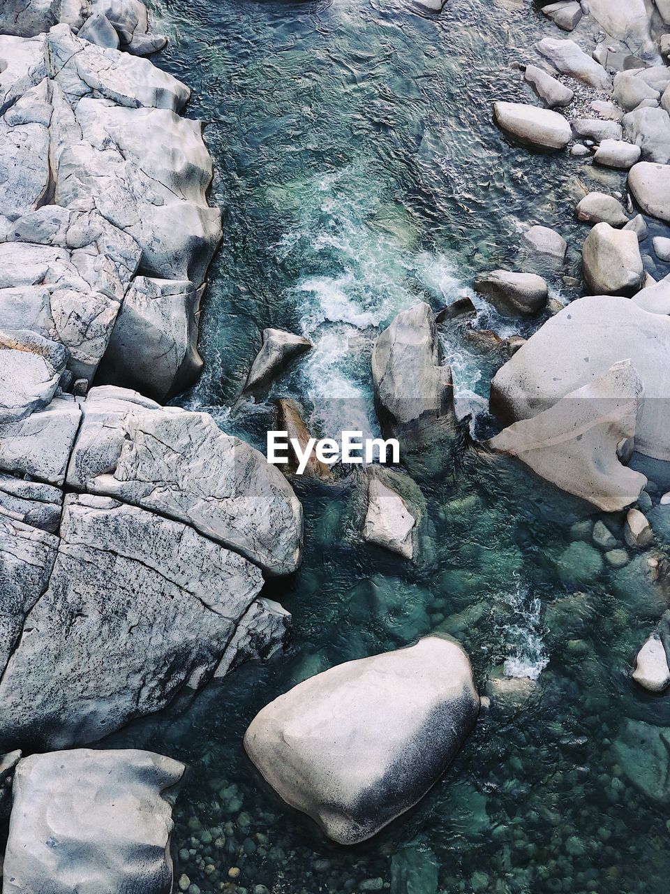 HIGH ANGLE VIEW OF STONES AT SHORE