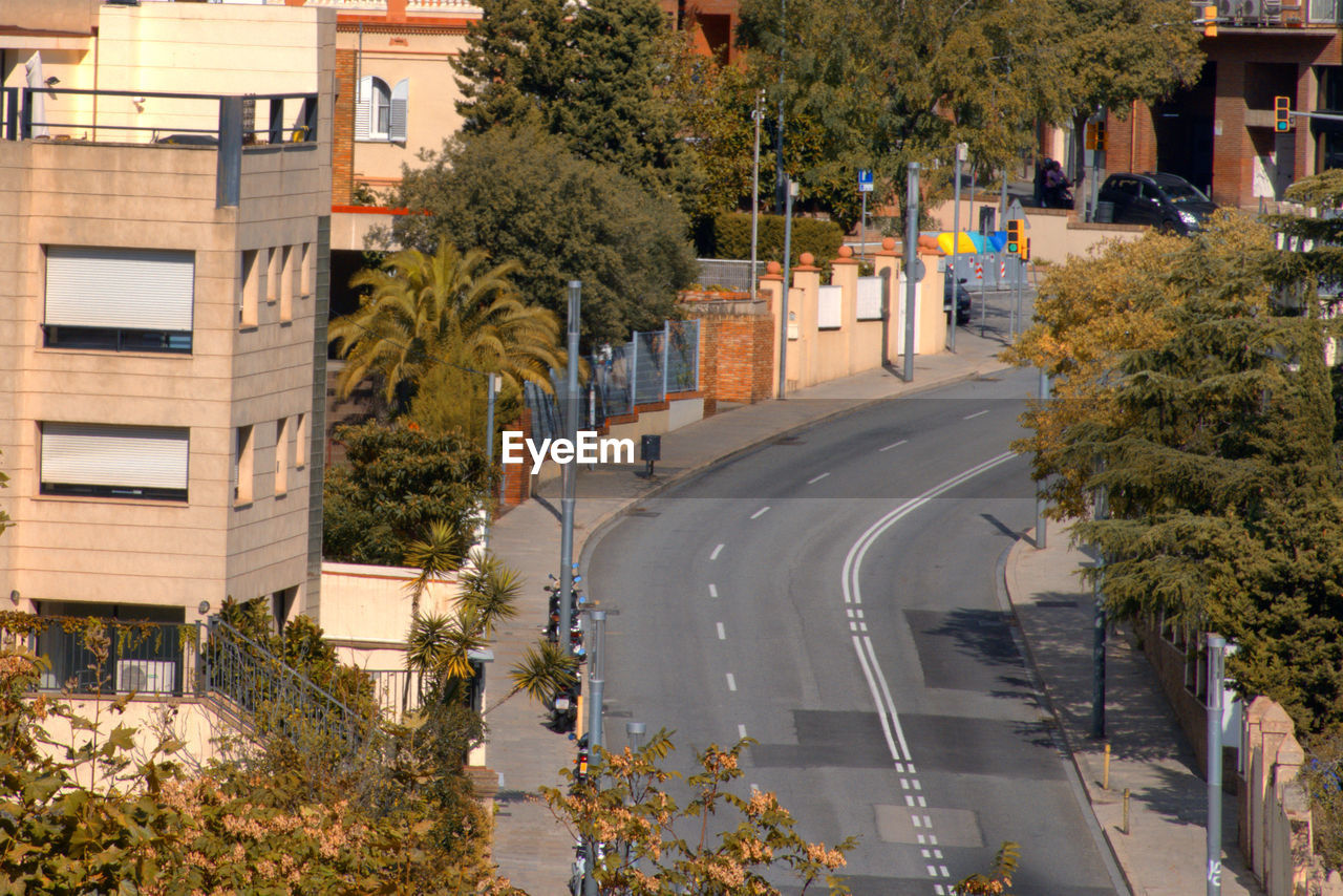 Street amidst trees and plants in city. vallcarca district in barcelona city