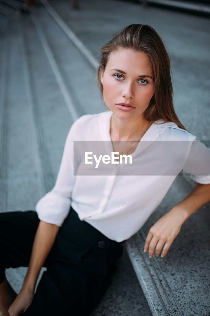 Portrait of businesswoman sitting on steps