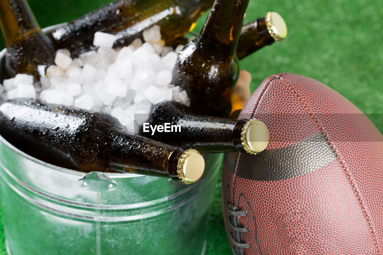 Close-up of beer bottles in container