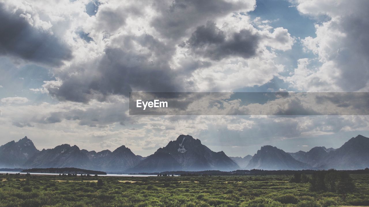 Scenic view of landscape against dramatic sky