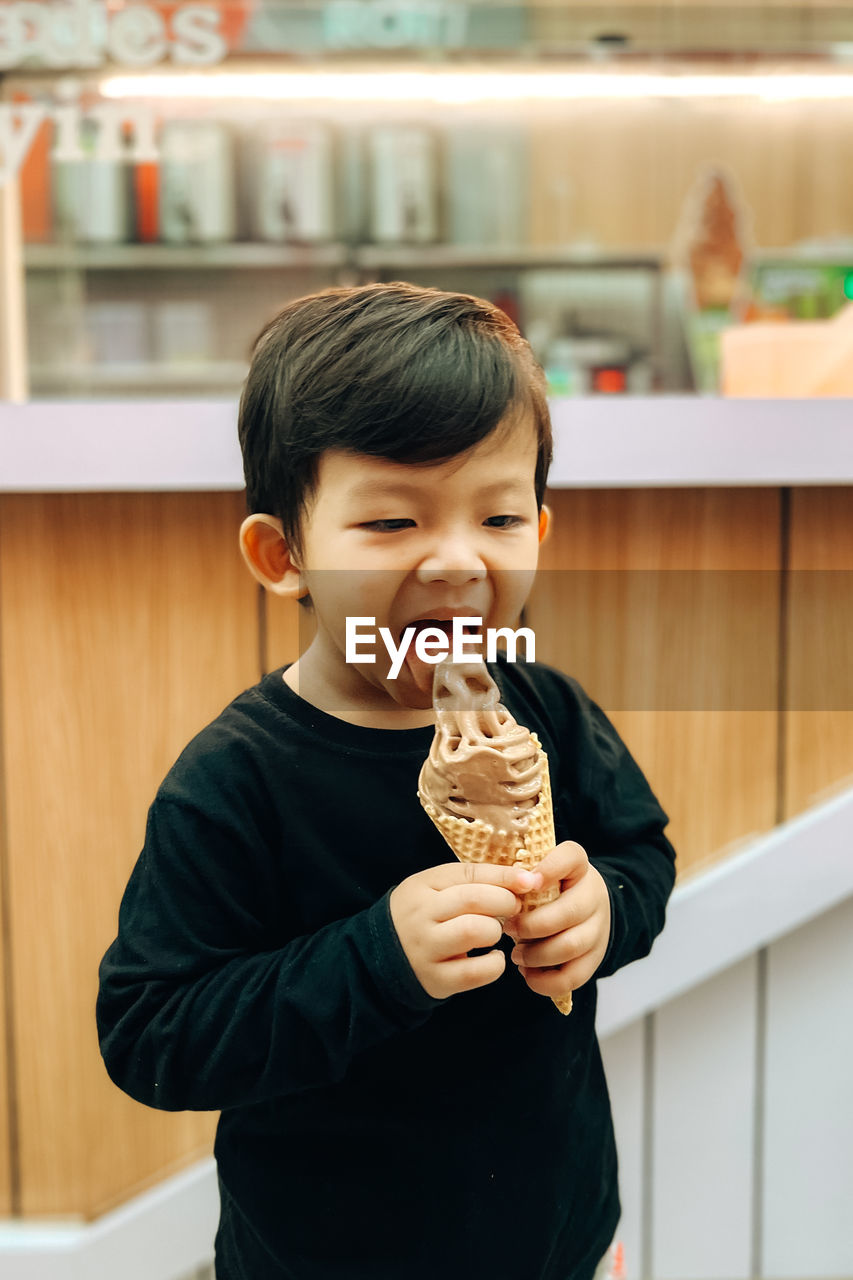A boy is enjoying ice cream
