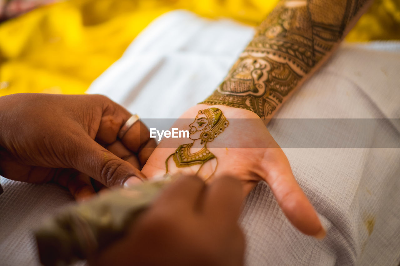 Hand of an indian bride decorated with henna or mehndi