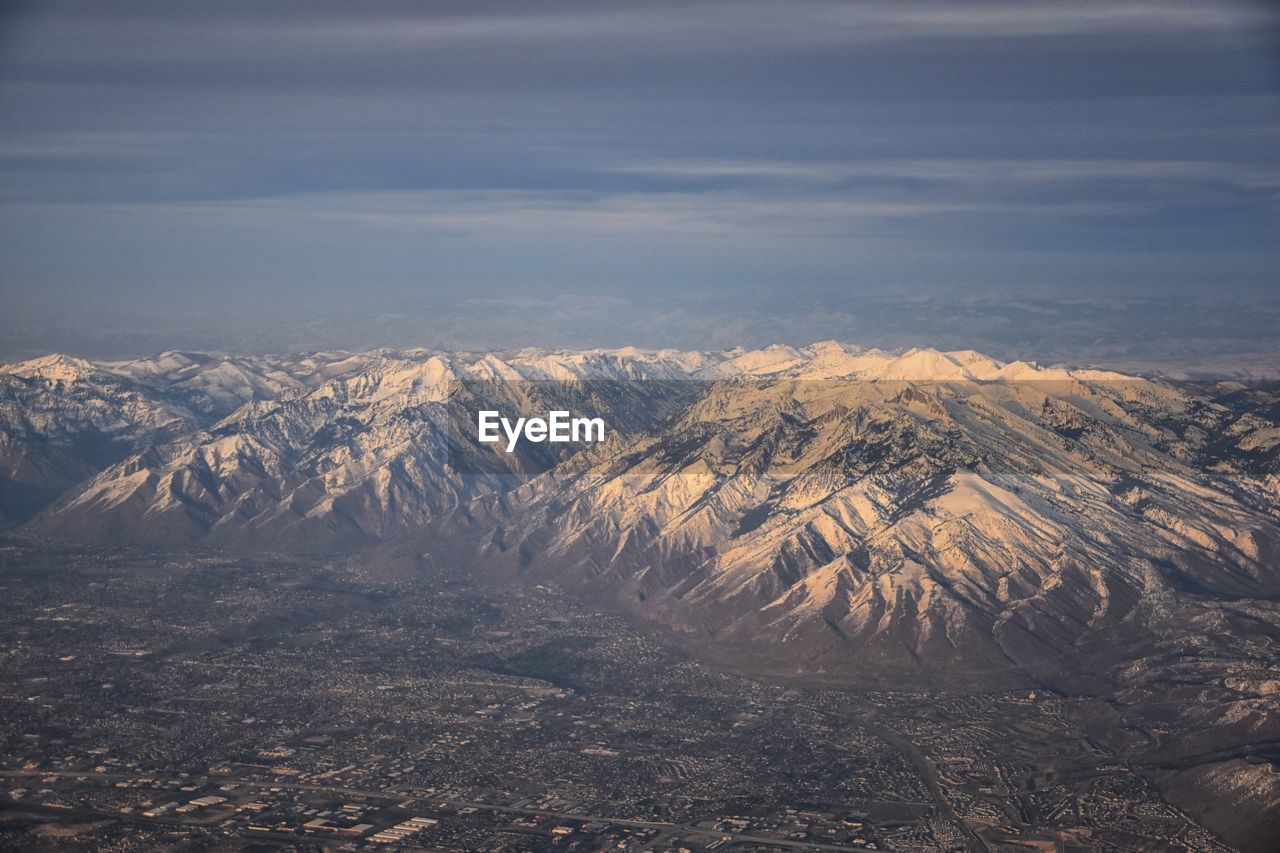 Wasatch front rocky mountain range aerial snow capped peaks winter urban salt lake city utah usa