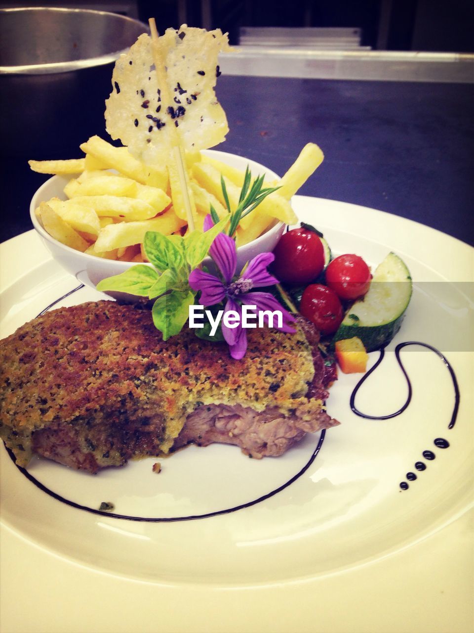 Grilled beef and french fries served in plate