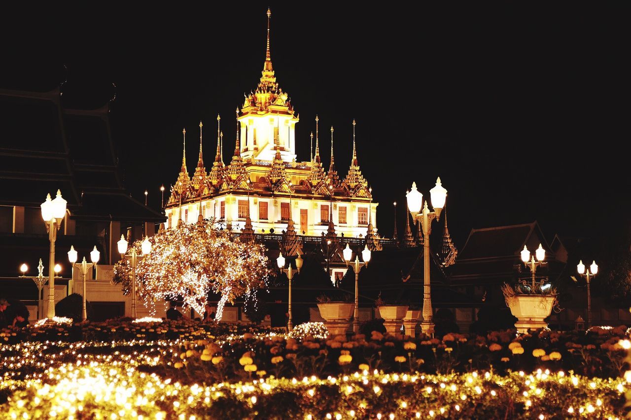 VIEW OF ILLUMINATED TEMPLE AT NIGHT