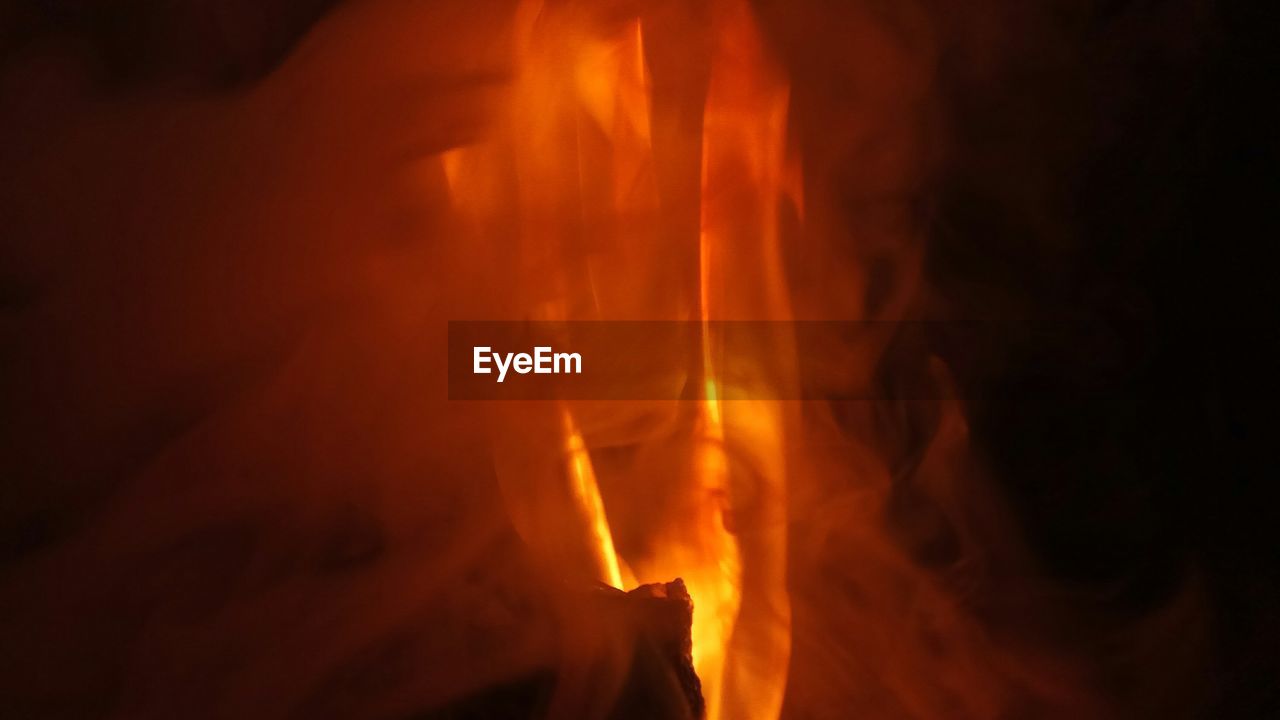 CLOSE-UP OF FIRE BURNING AT NIGHT