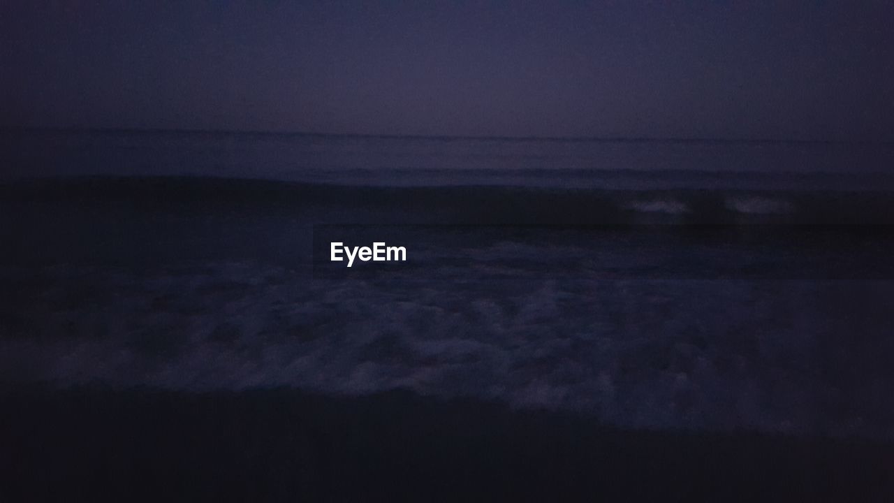 SCENIC VIEW OF SEA AGAINST SKY AT SUNSET