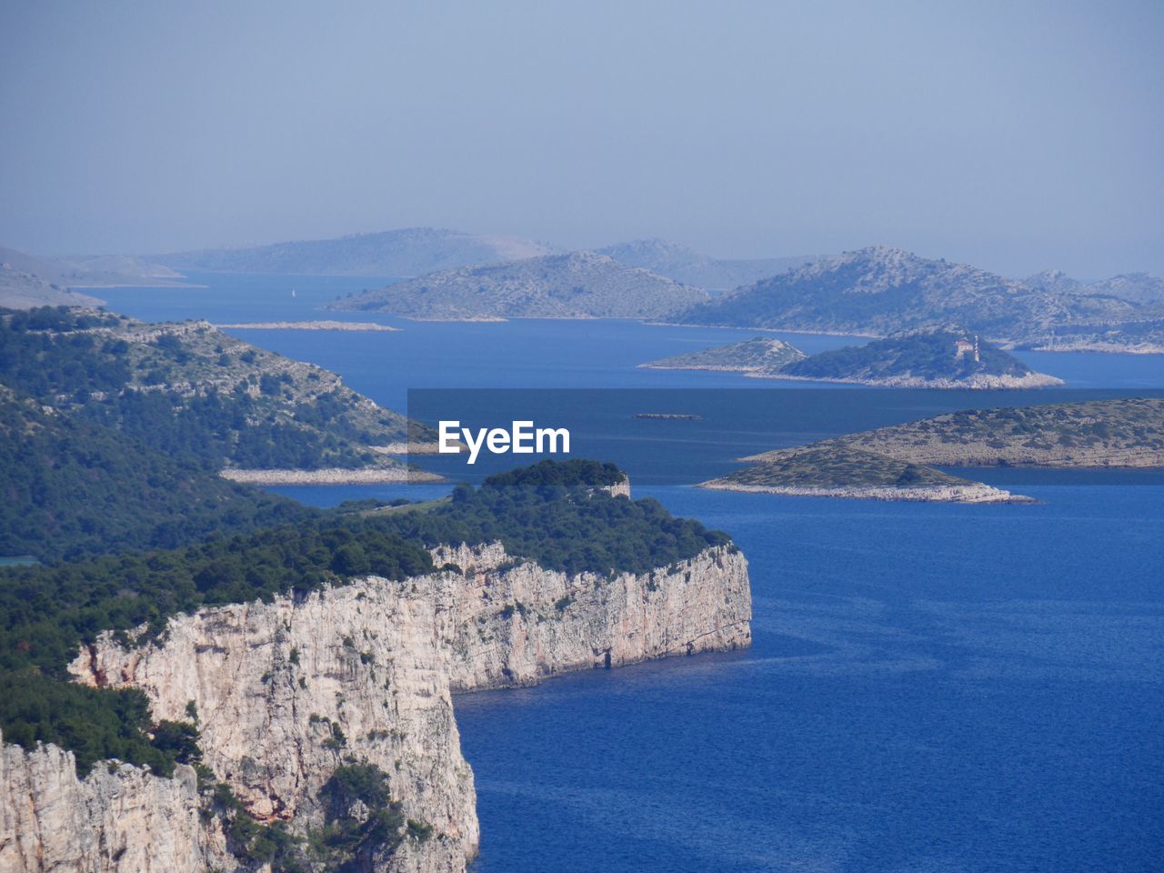 High angle view of sea and mountains against sky