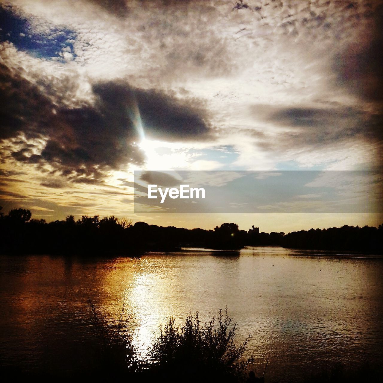 SCENIC VIEW OF SUNSET OVER LAKE