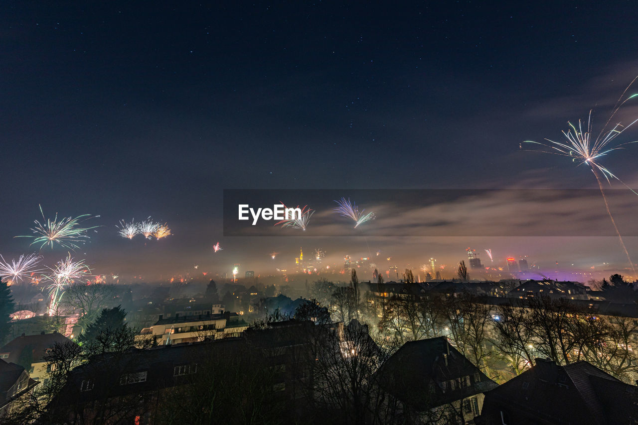 AERIAL VIEW OF ILLUMINATED CITY AT NIGHT