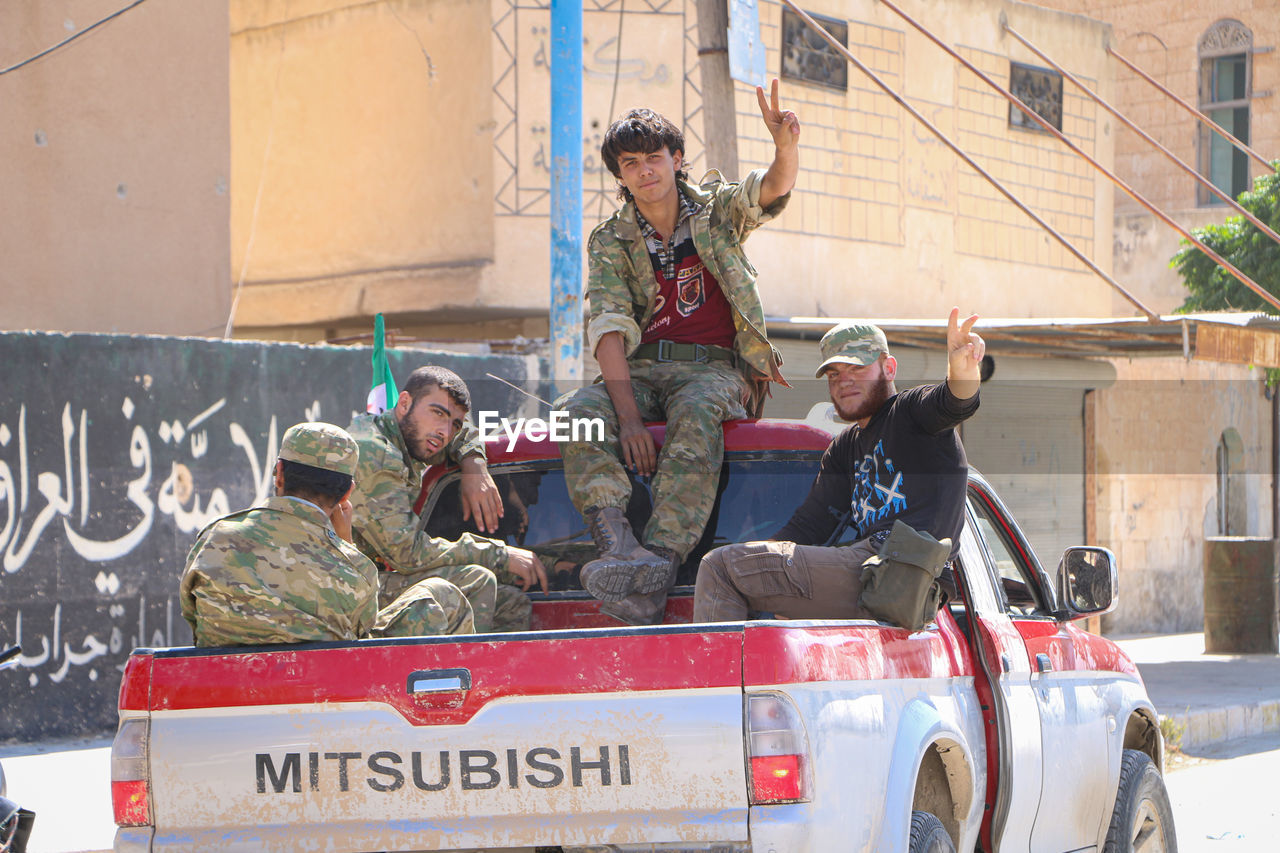 PORTRAIT OF PEOPLE SITTING IN CAR