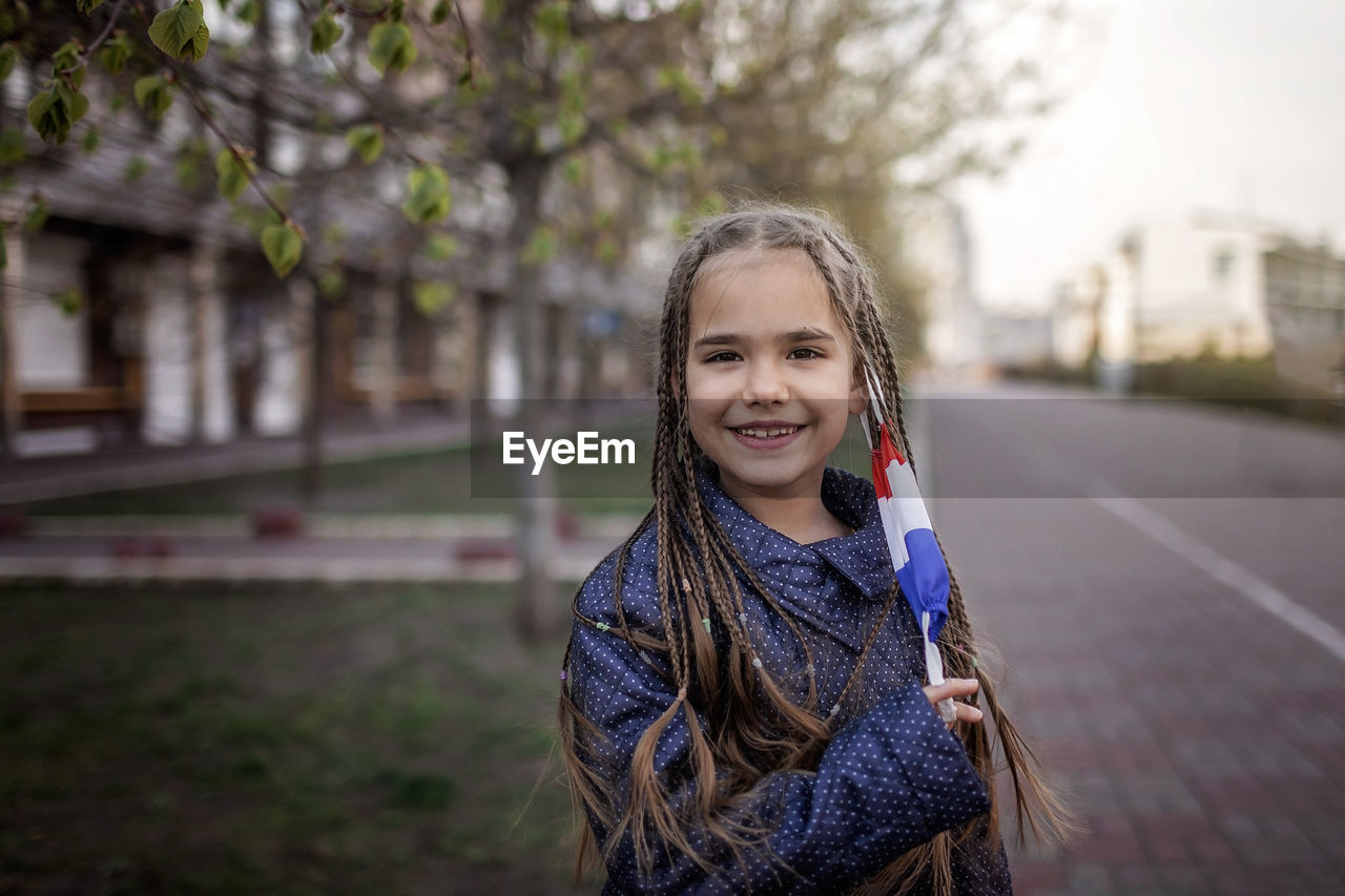 Portrait of girl standing on street