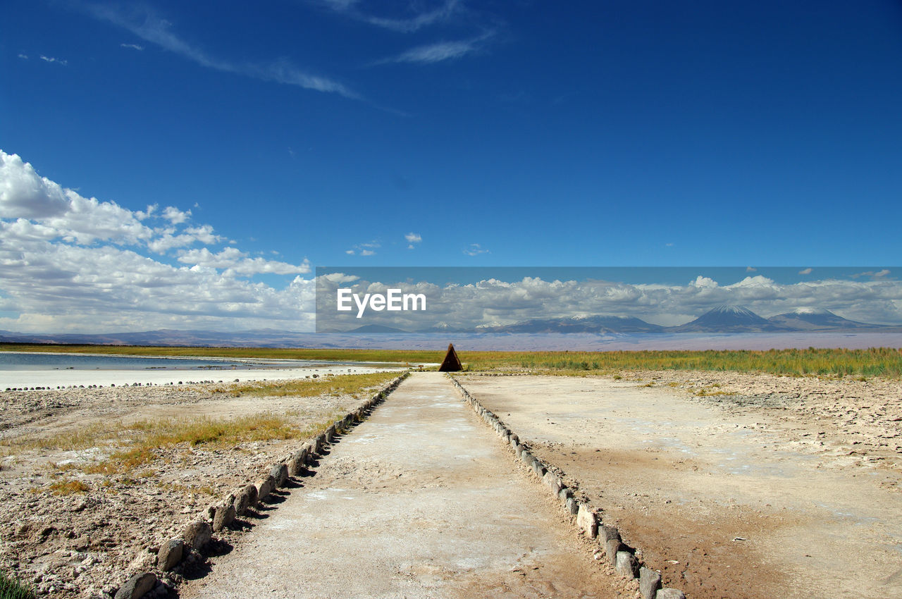 Surface level of road on field against sky