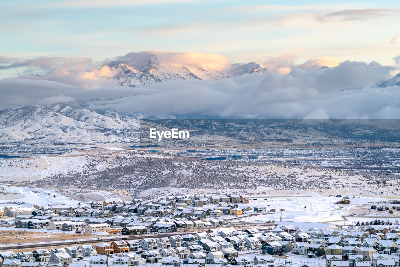 AERIAL VIEW OF TOWNSCAPE AND MOUNTAINS DURING WINTER