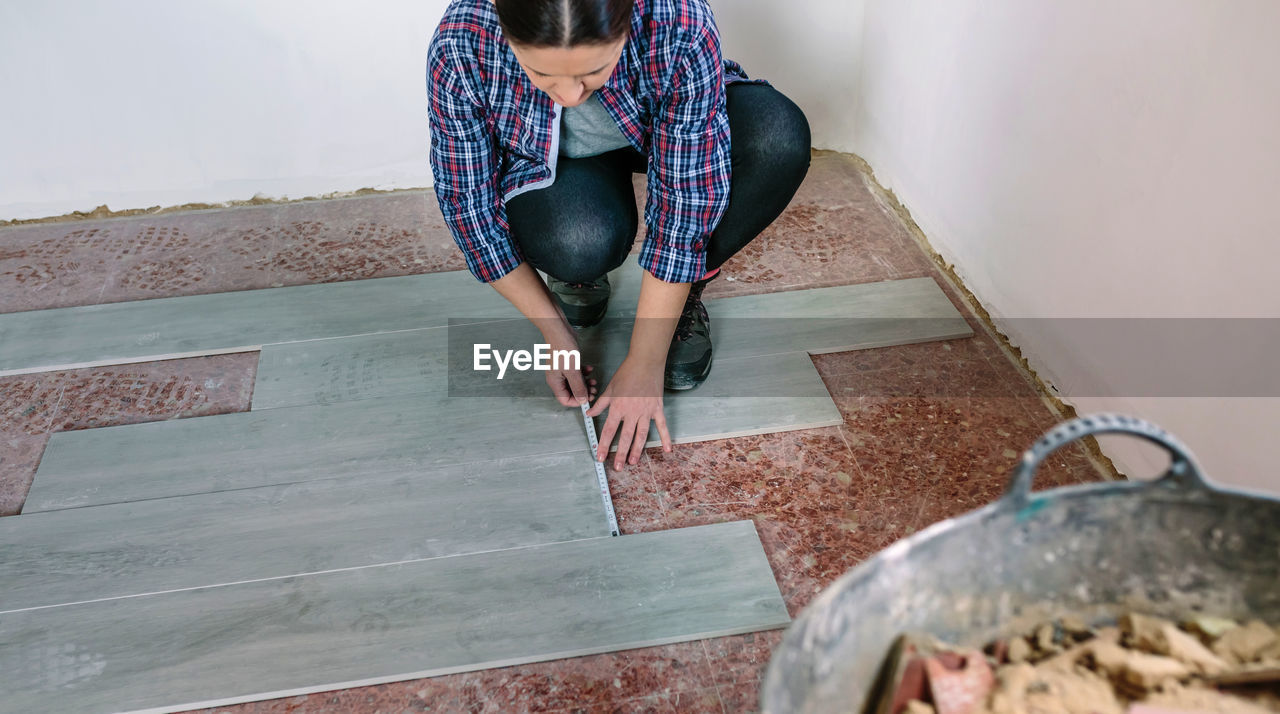 Female tile worker working at home