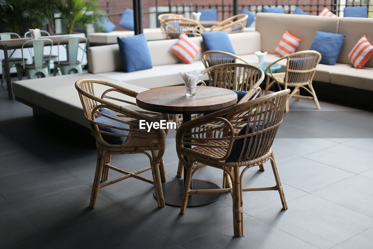 EMPTY CHAIRS AND TABLES IN RESTAURANT