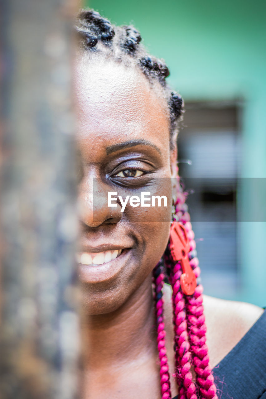 Close-up portrait of smiling woman with braided hair