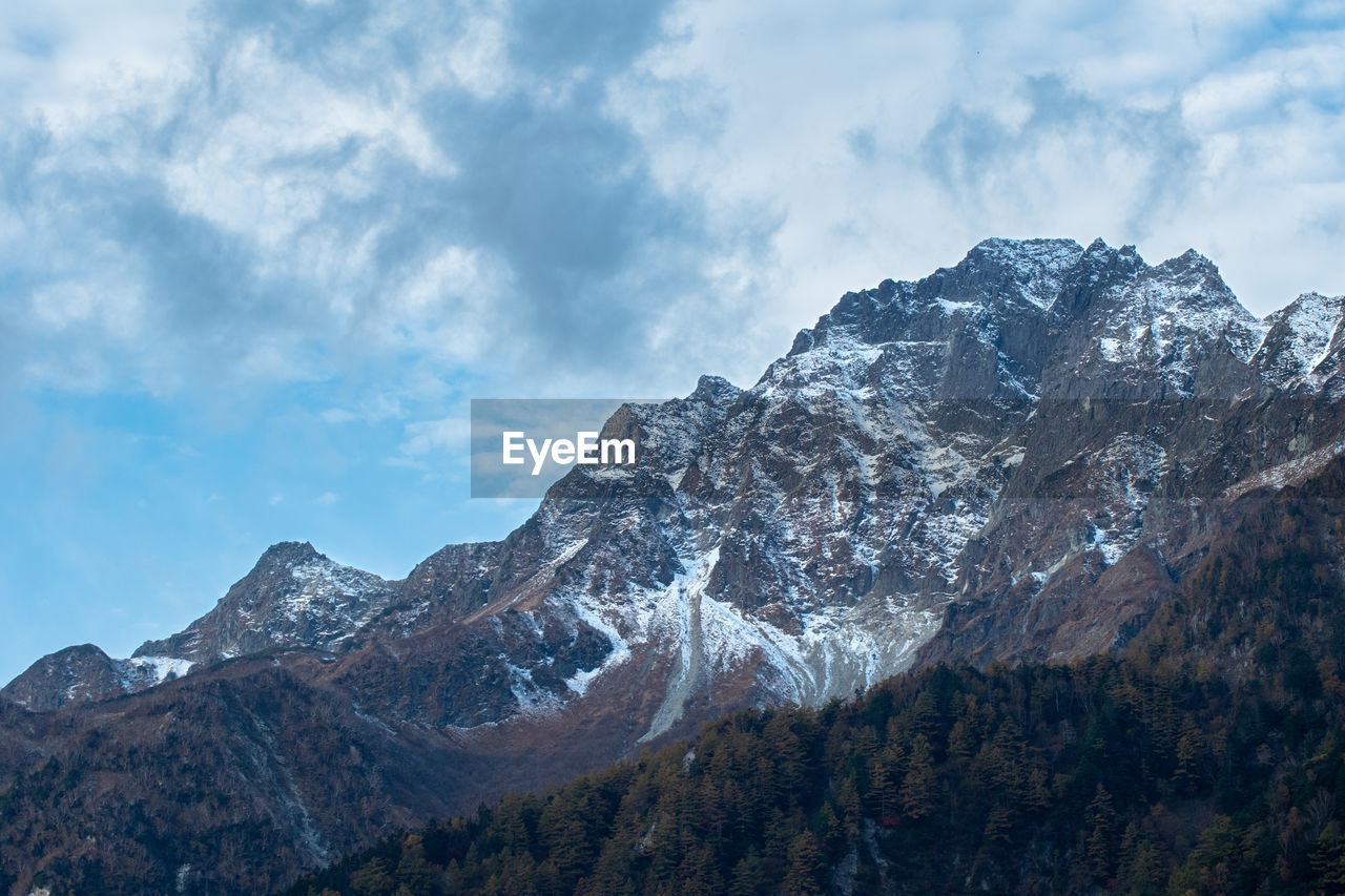 mountain, nature, scenics - nature, sky, mountain range, environment, landscape, snow, cloud, beauty in nature, cold temperature, winter, wilderness, mountain peak, snowcapped mountain, land, ridge, travel destinations, travel, no people, summit, rock, outdoors, mountain pass, tourism, activity, forest, plant, tree, plateau, blue, pinaceae, coniferous tree, pine tree, tranquility, leisure activity, day, tranquil scene, pine woodland, non-urban scene, adventure