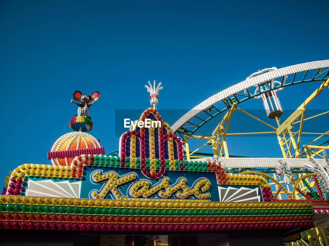 LOW ANGLE VIEW OF ROLLERCOASTER AGAINST CLEAR BLUE SKY