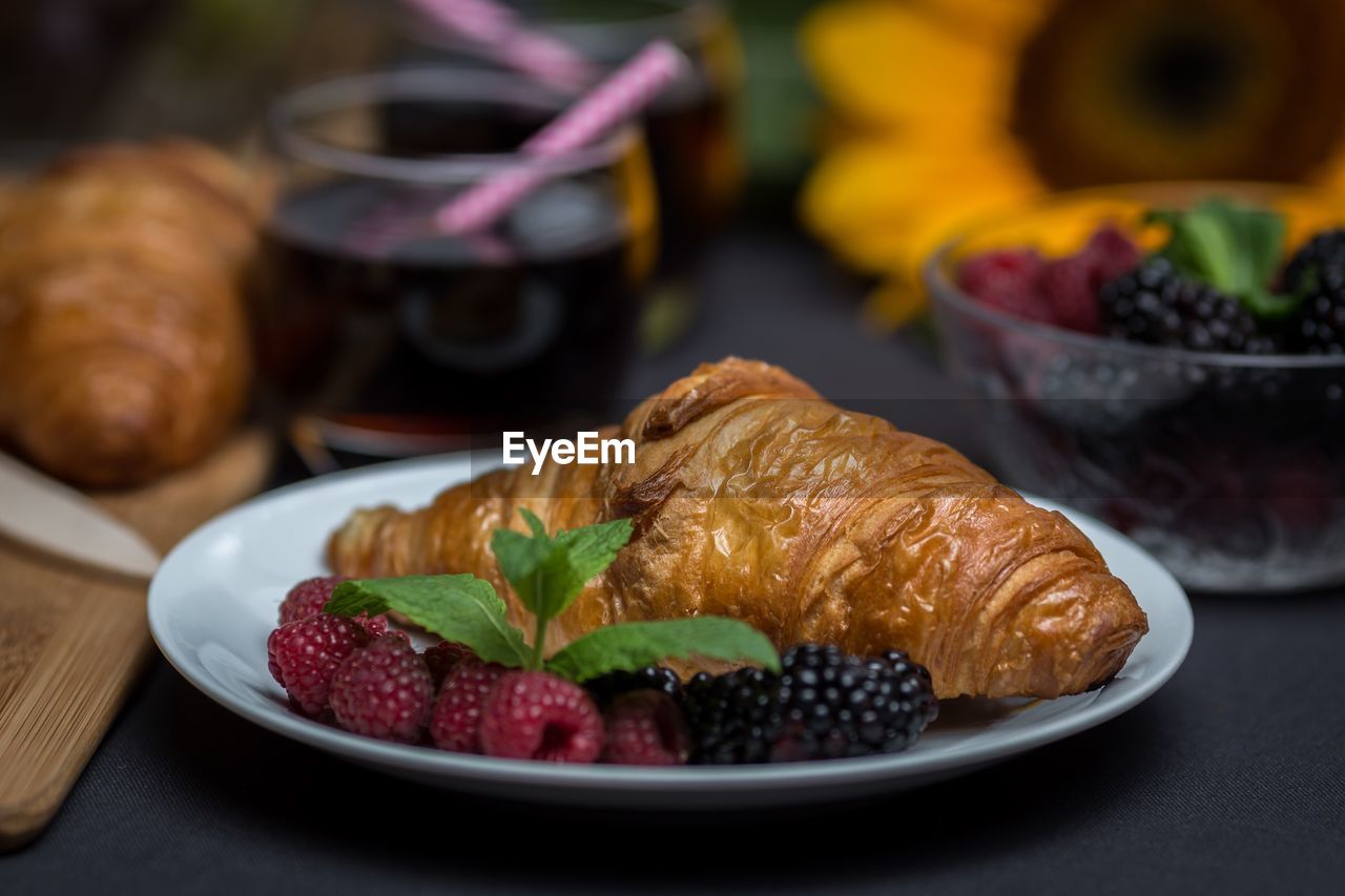 Close-up of croissants with berries on table