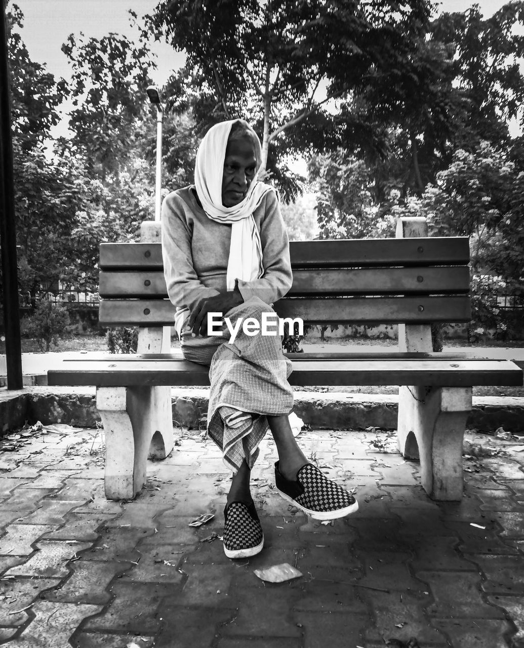 Man sitting on bench in park