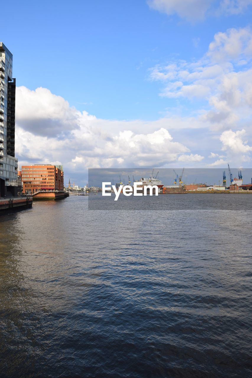 Scenic view of sea by city against sky