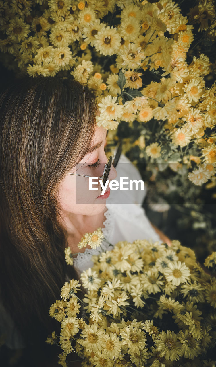 High angle view of woman by flowering plants