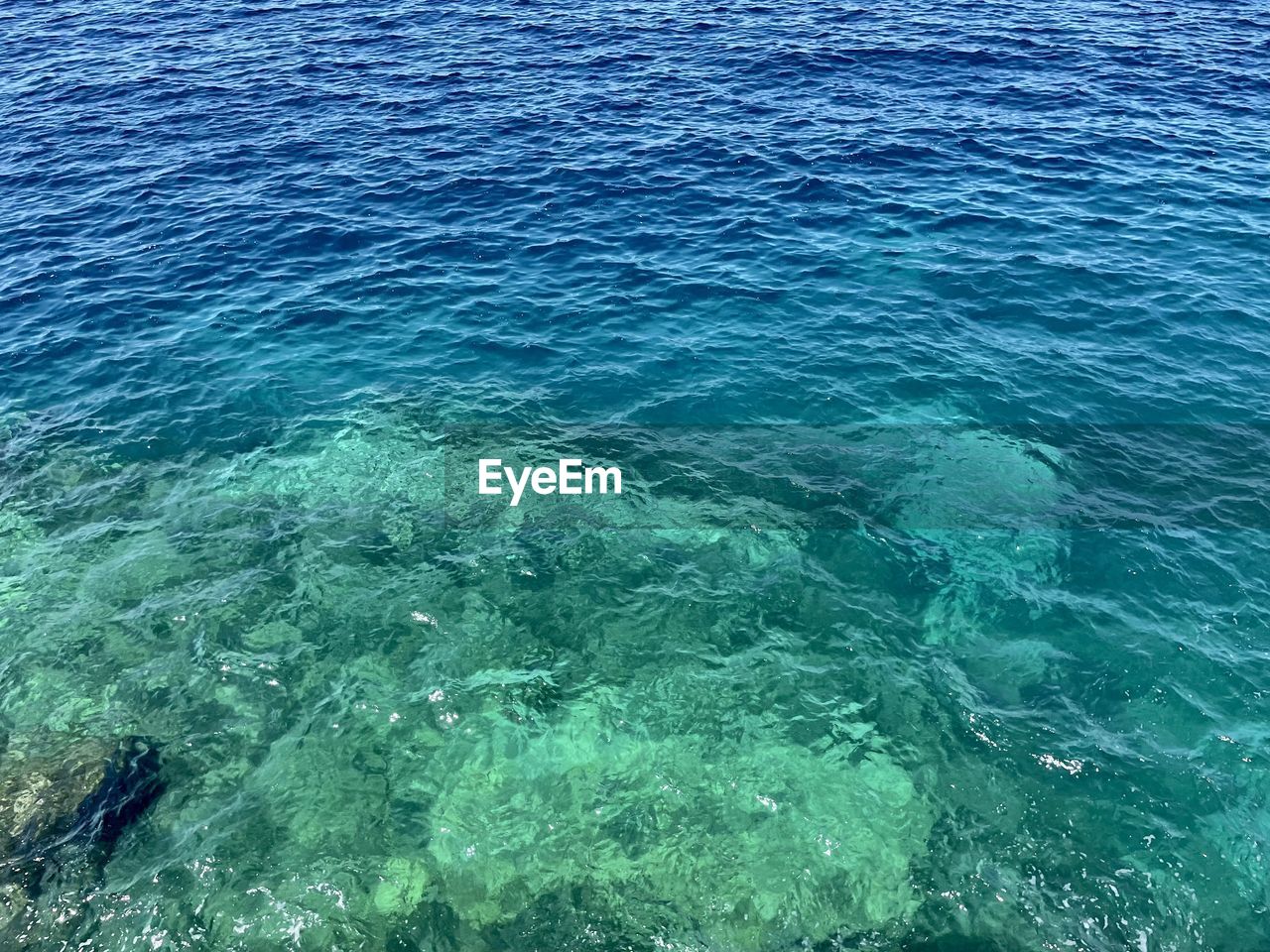 water, sea, beauty in nature, high angle view, ocean, day, nature, scenics - nature, tranquility, waterfront, blue, no people, wind wave, turquoise colored, tranquil scene, rippled, outdoors, marine biology, idyllic, coast, land, reef, coral reef, wave, sunlight