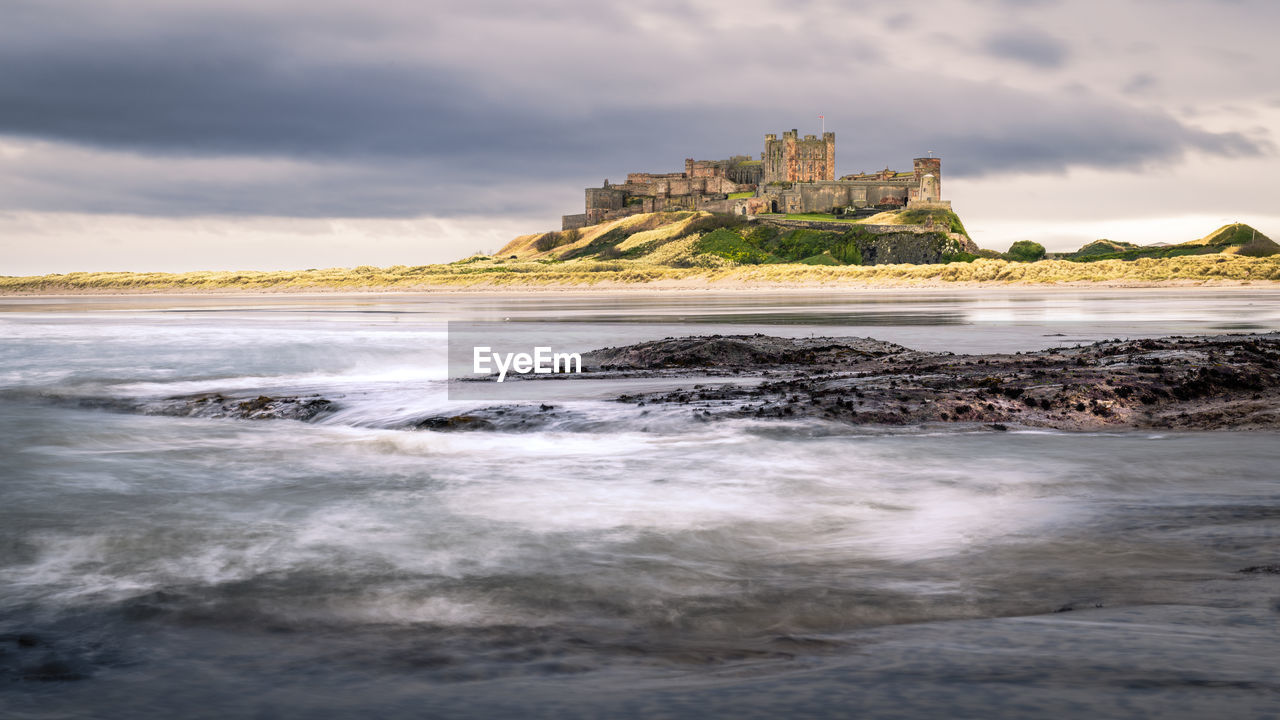 Bamburgh castle is on the northeast coast of england, by the village of bamburgh in northumberland.