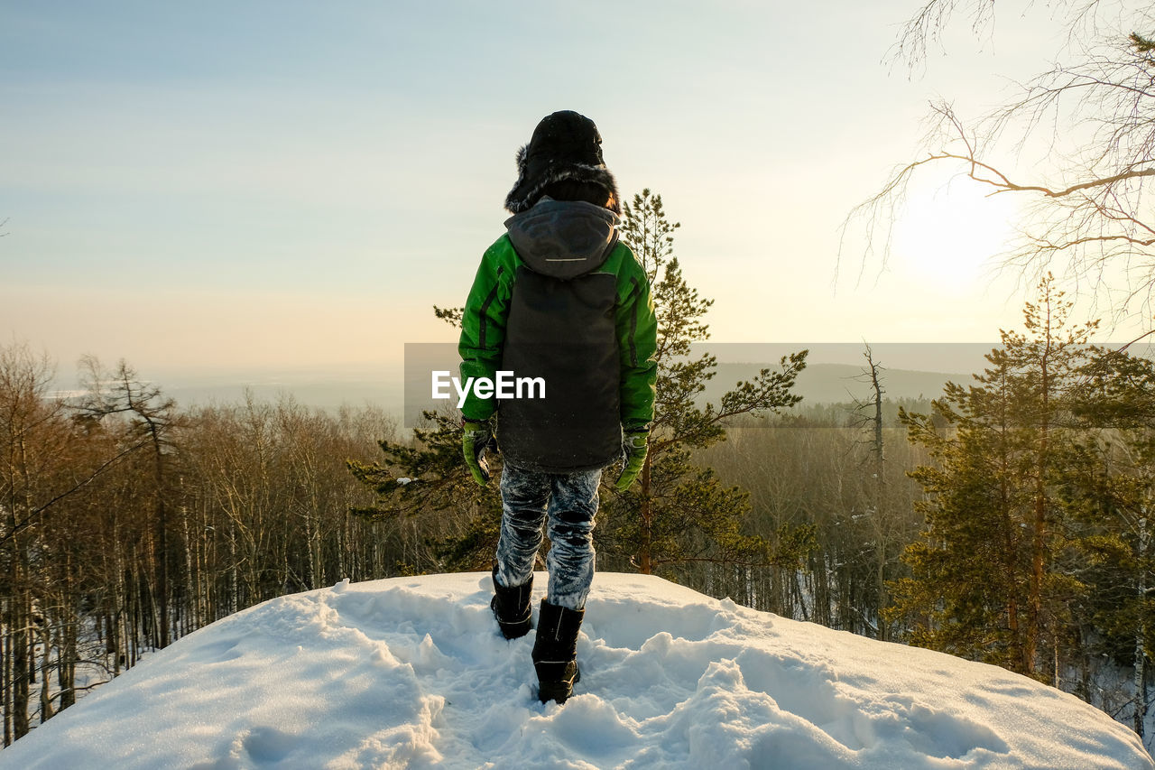 А severe hiker walking along the mountain path route. the urals landsc