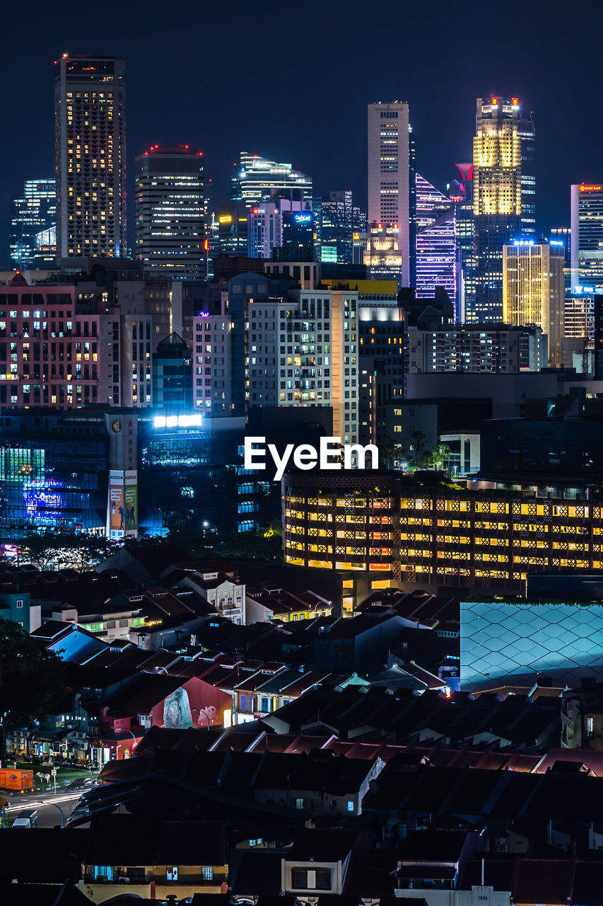 High angle view of illuminated buildings in city at night