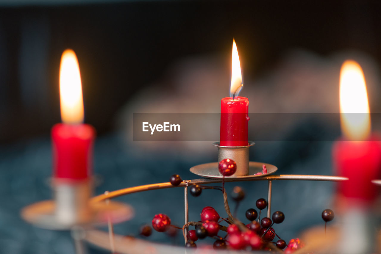CLOSE-UP OF LIT CANDLE