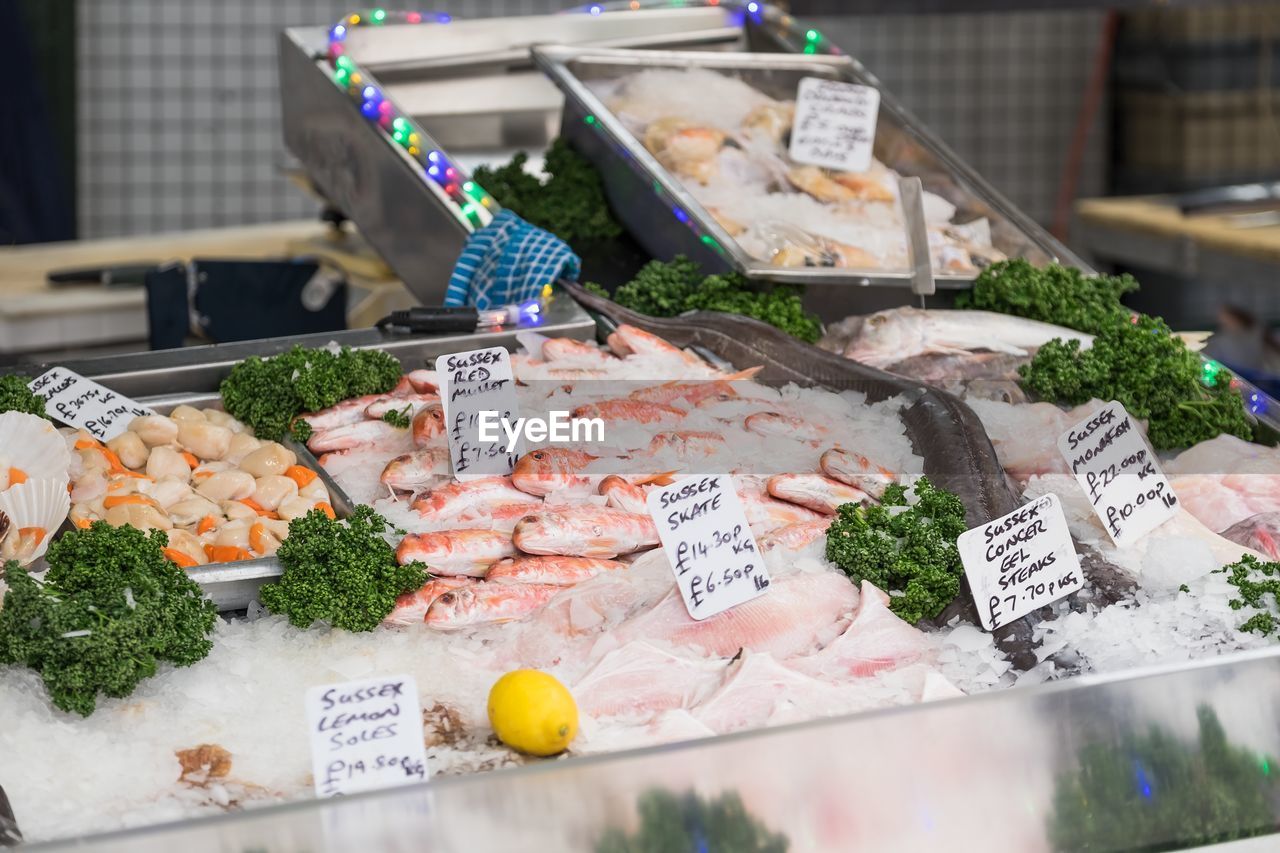 High angle view of fresh seafood with labels at market stall