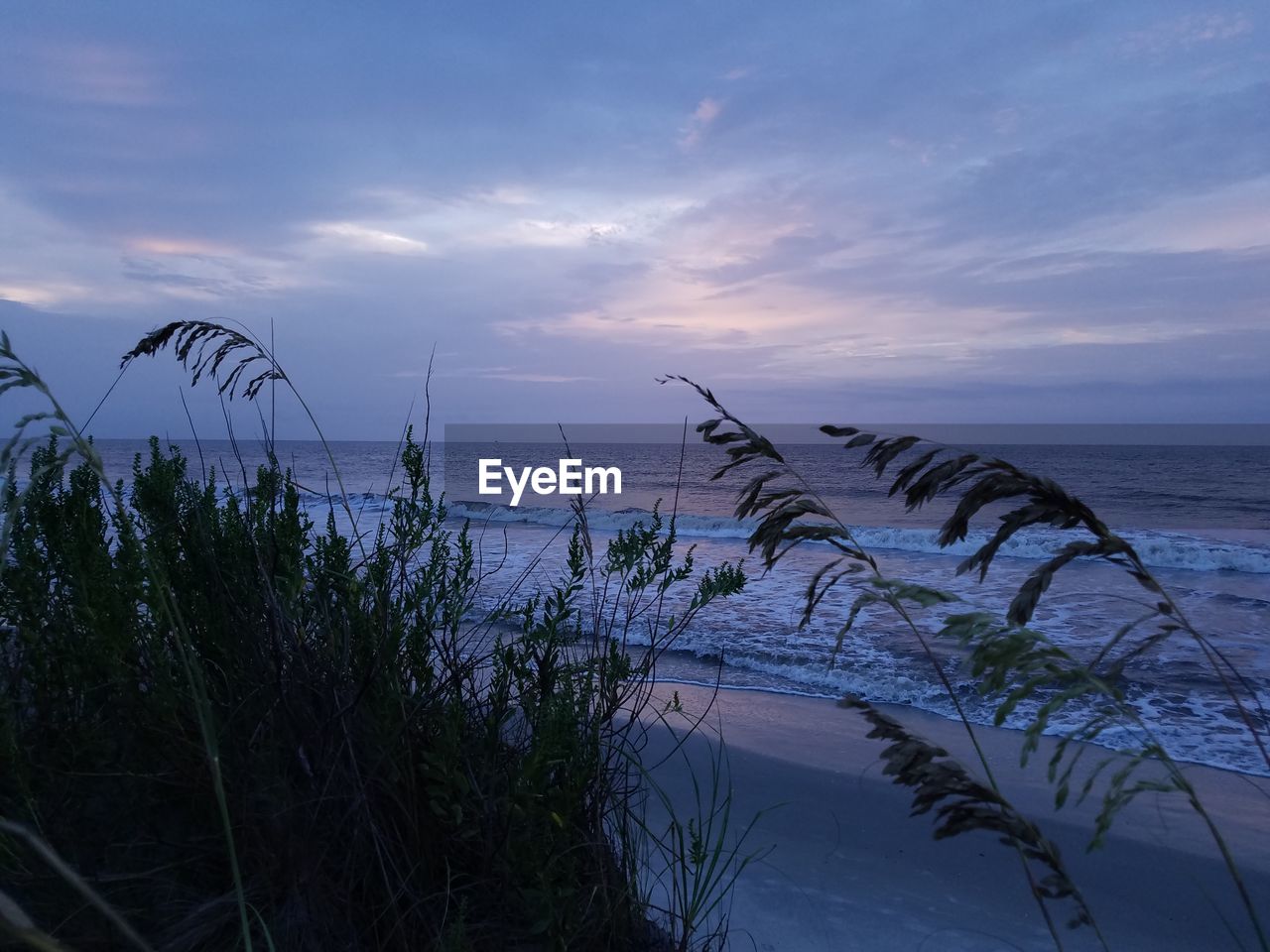 Scenic view of sea against sky at sunset