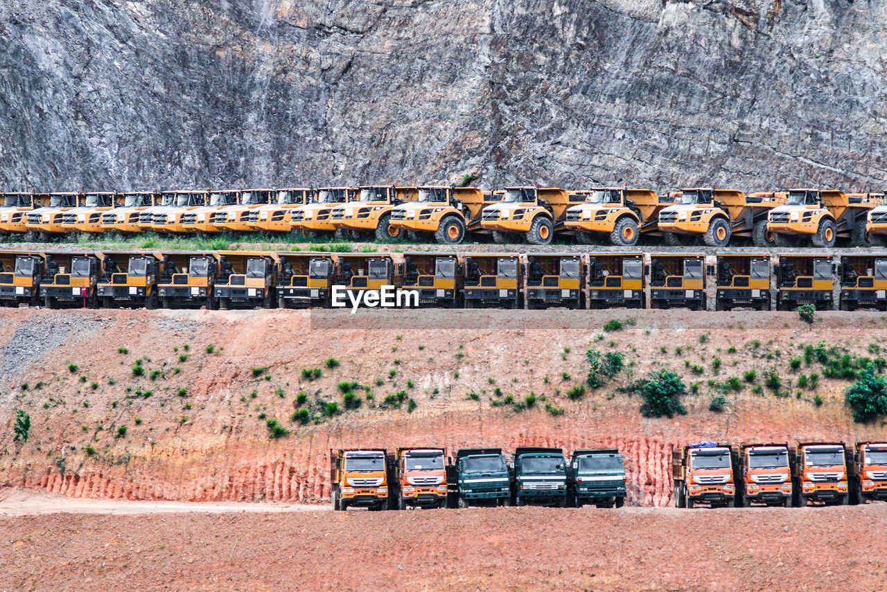 Trucks parked against mountain