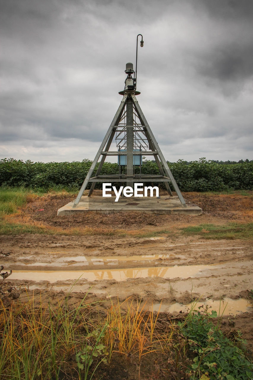 Built structure on field against sky