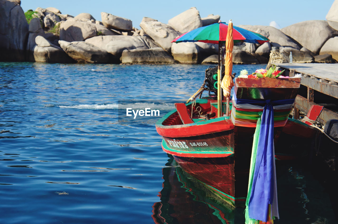 BOATS MOORED ON SEA SHORE