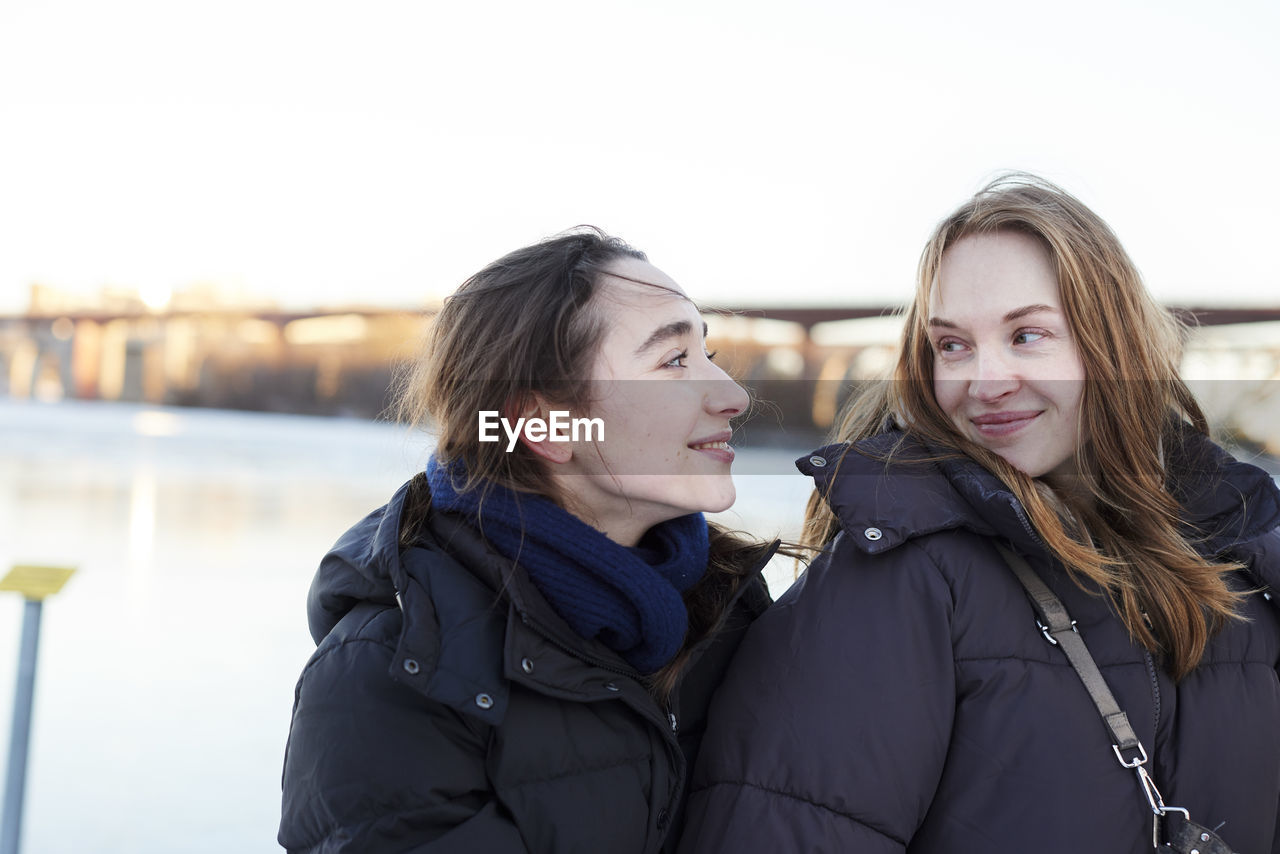 Smiling female couple in winter scenery