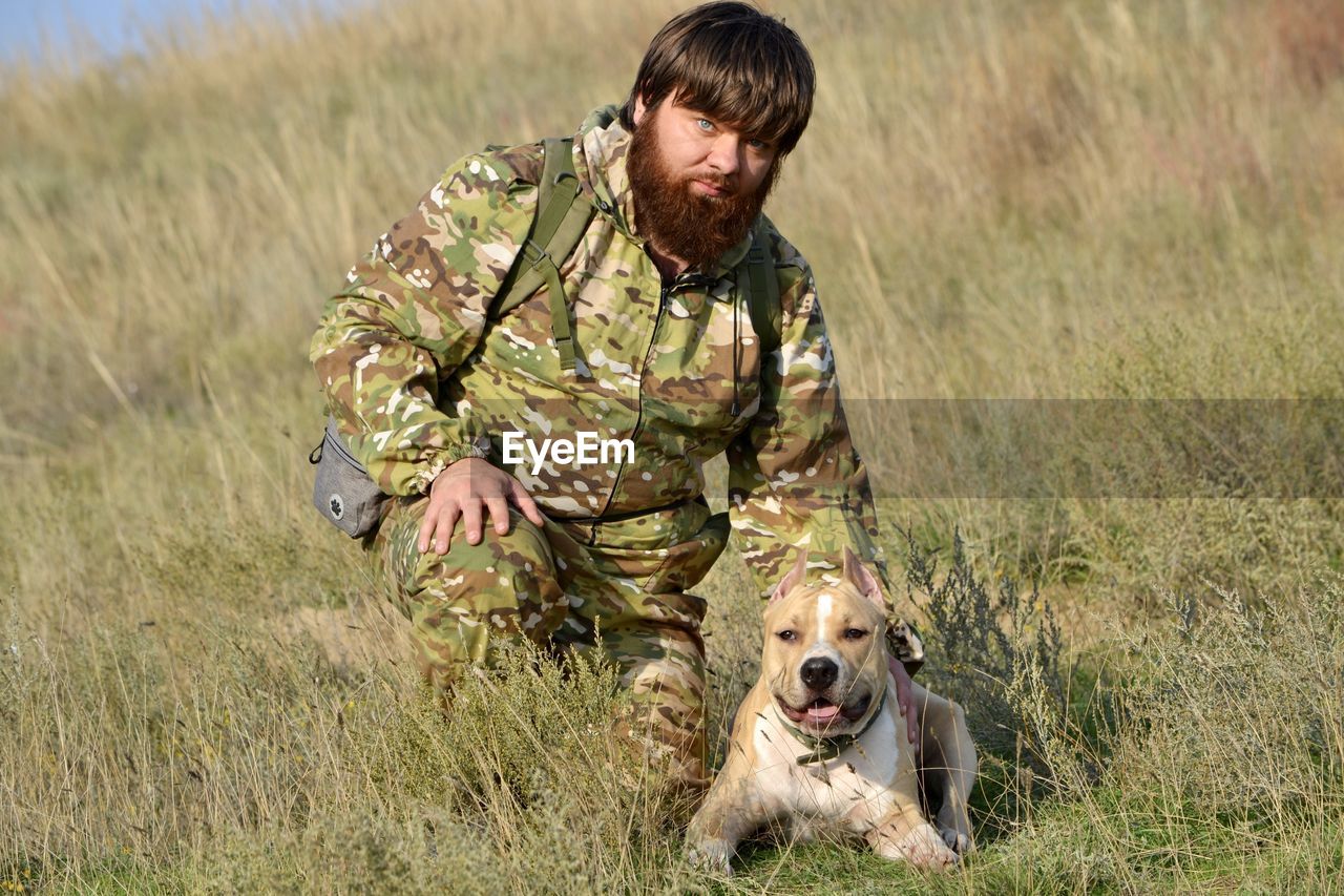 BOY WITH DOG IN MOUTH