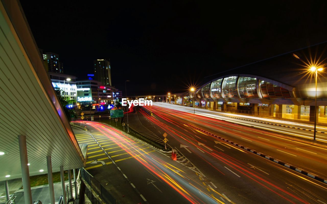 LIGHT TRAILS ON CITY STREET AT NIGHT