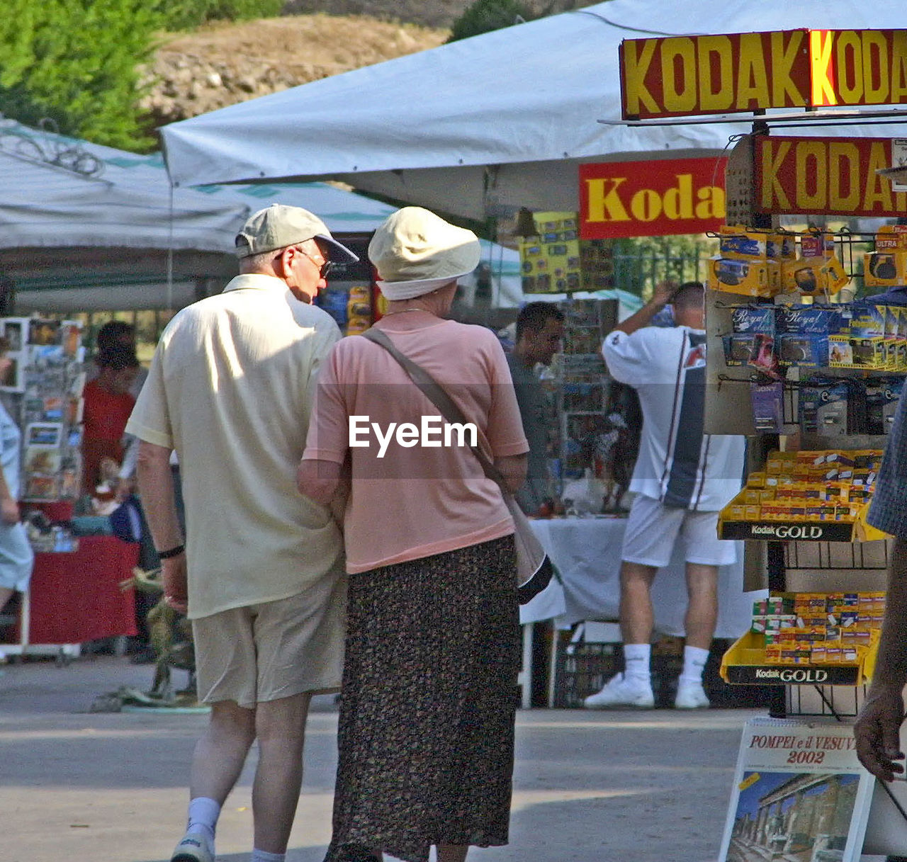 REAR VIEW OF PEOPLE IN MARKET